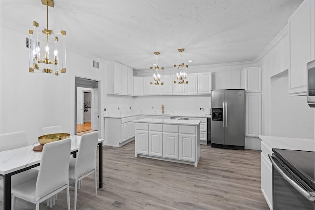 108 Dustin Cir, Hudson Oaks, TX 76087 - kitchen featuring a sink, visible vents, a chandelier, stainless steel fridge, and white cabinets