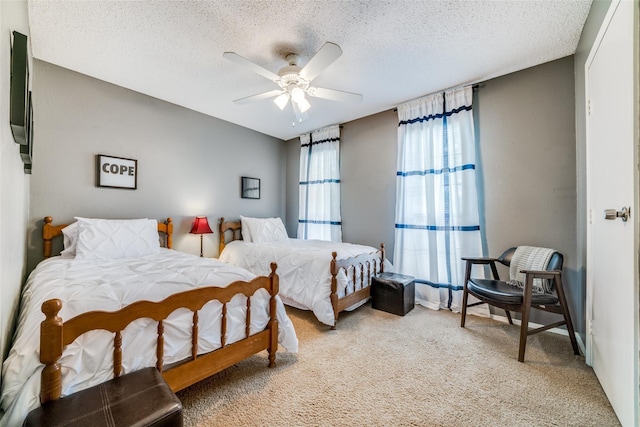 bedroom with light colored carpet, a textured ceiling, and ceiling fan