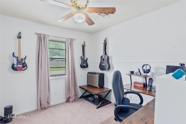 carpeted office space with baseboards, ceiling fan, and visible vents