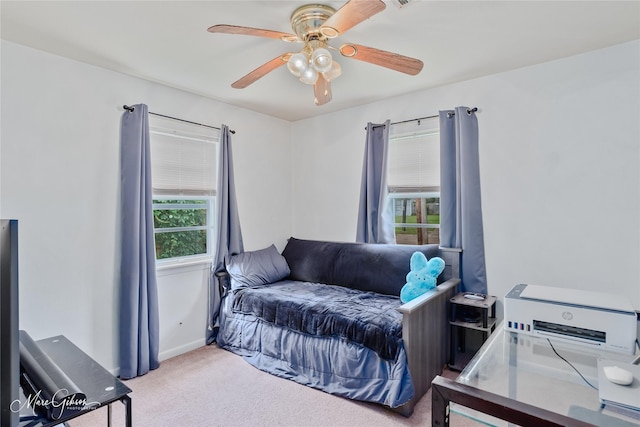 carpeted bedroom featuring a ceiling fan and baseboards