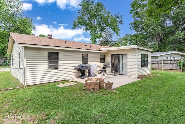 rear view of property featuring a yard, a patio, and a fenced backyard
