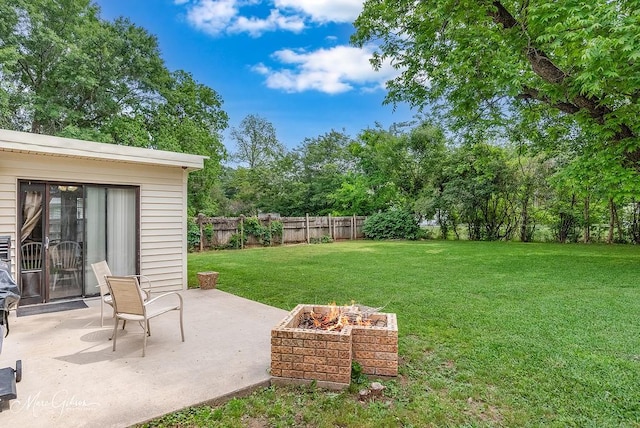 view of yard featuring a fenced backyard, a patio area, and an outdoor fire pit