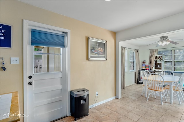dining area with baseboards, ceiling fan, and light tile patterned floors