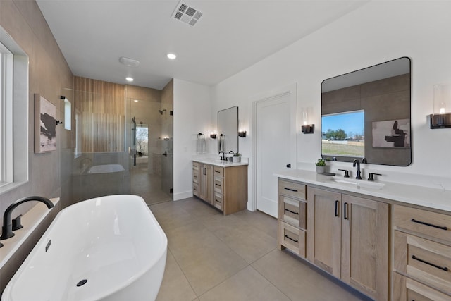 238 Glenview Cir, Belton, TX 76513 - full bathroom with visible vents, a shower stall, two vanities, a sink, and tile patterned floors