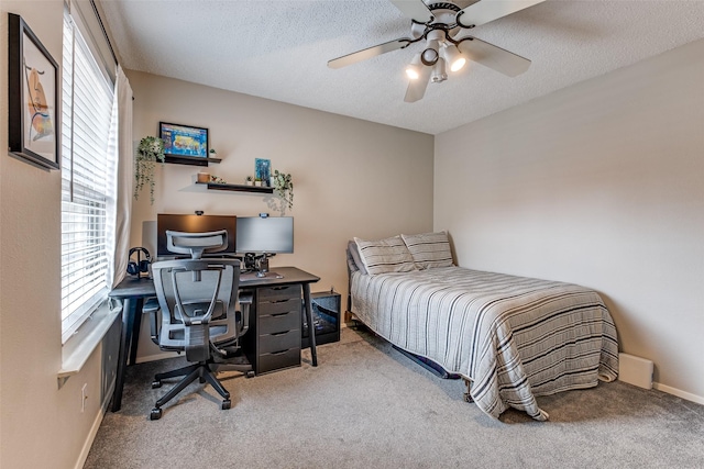 bedroom with carpet floors, a textured ceiling, and multiple windows