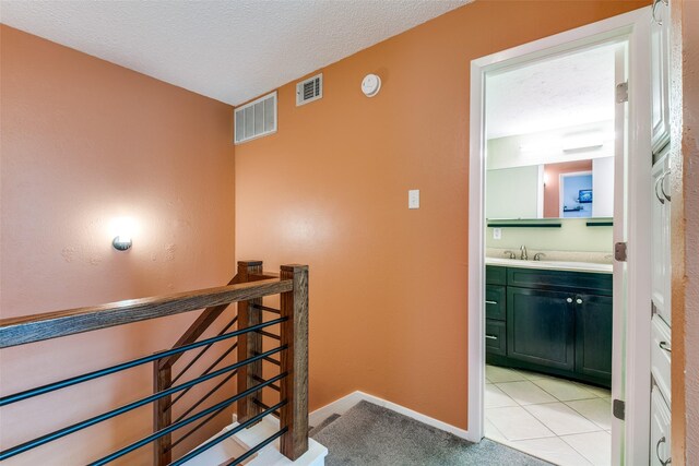staircase with visible vents, carpet flooring, and baseboards