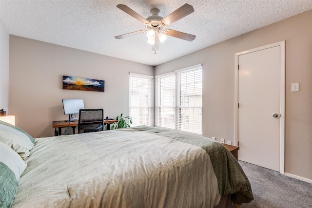 bedroom featuring carpet flooring, a ceiling fan, and a textured ceiling