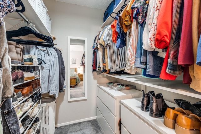 walk in closet with carpet flooring