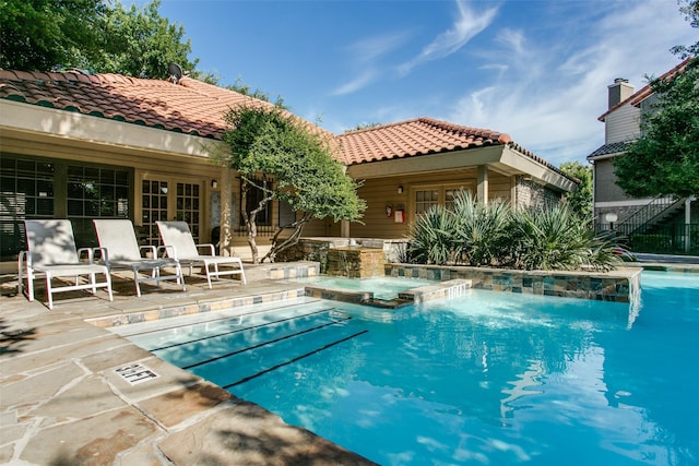 view of swimming pool featuring a patio and a pool with connected hot tub