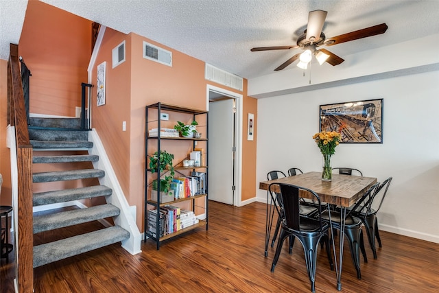 dining room featuring stairway, a ceiling fan, wood finished floors, and visible vents