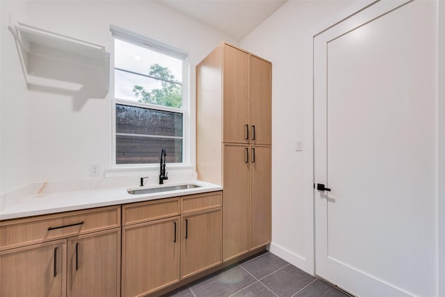 interior space featuring dark tile patterned floors and a sink