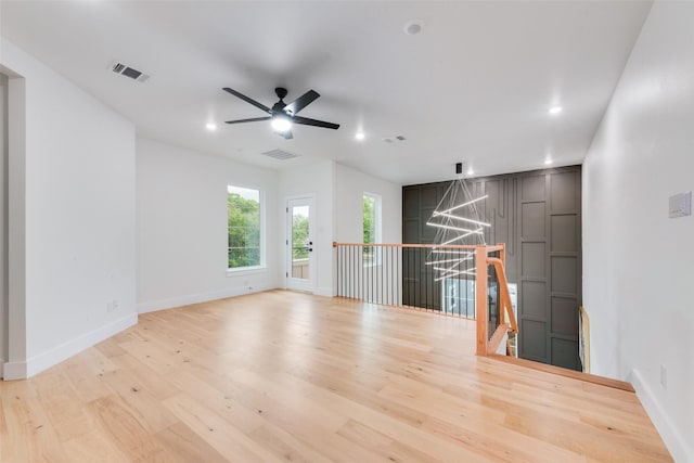 unfurnished room featuring recessed lighting, baseboards, visible vents, and light wood-style floors
