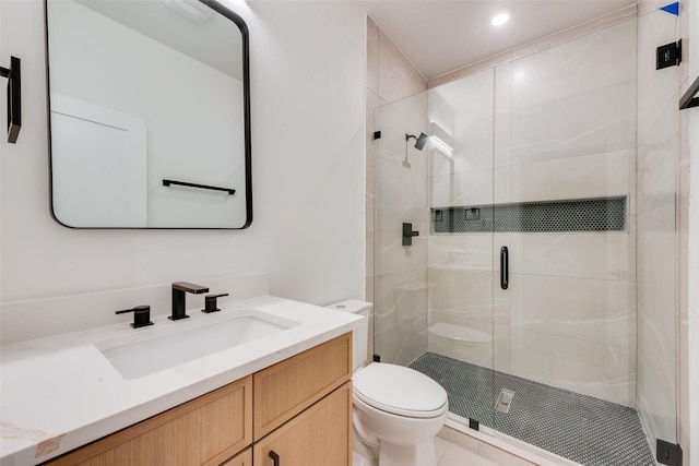 bathroom featuring vanity, recessed lighting, a stall shower, and toilet