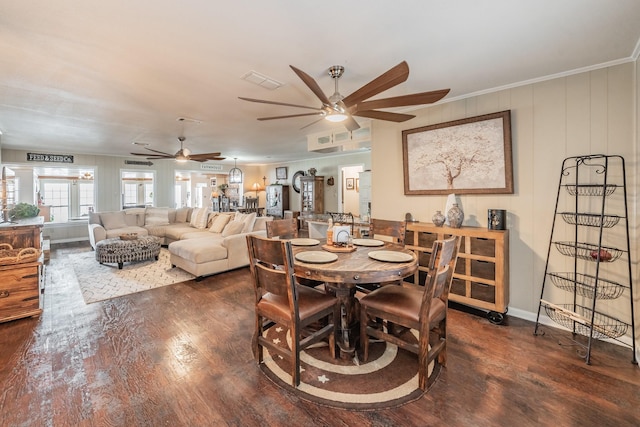 dining area with crown molding, ceiling fan, wood finished floors, and visible vents