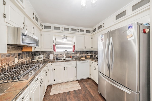 kitchen with dark wood-style flooring, appliances with stainless steel finishes, a sink, white cabinets, and glass insert cabinets