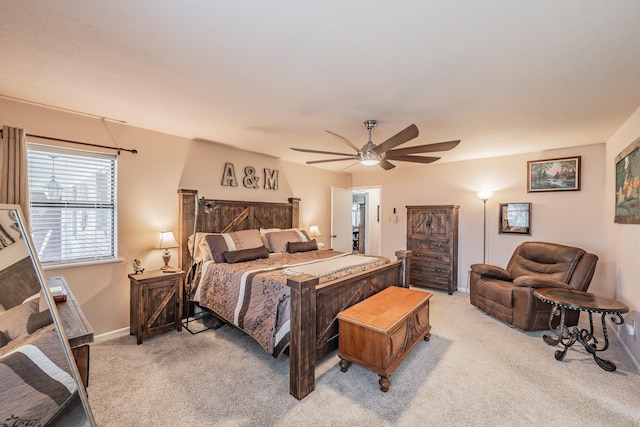 bedroom featuring baseboards, light carpet, and ceiling fan