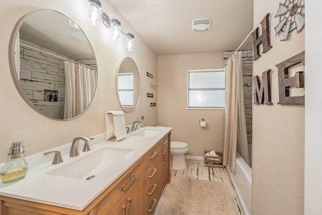 full bath featuring a sink, toilet, double vanity, and shower / bath combination with curtain