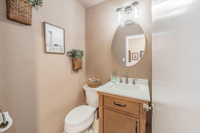 half bath with vanity and toilet
