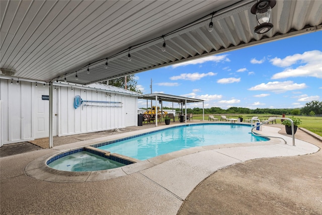 view of swimming pool featuring a patio and a pool with connected hot tub