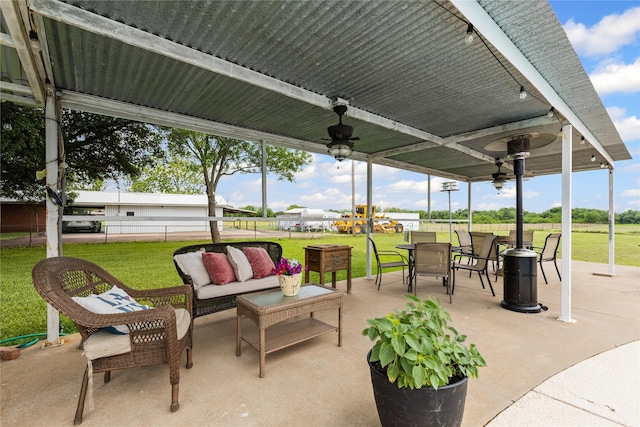 view of patio / terrace with an outdoor living space, a ceiling fan, fence, and outdoor dining space