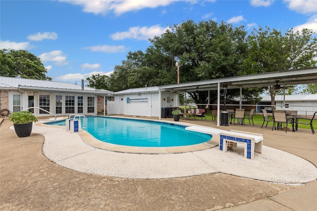 outdoor pool featuring fence and a patio