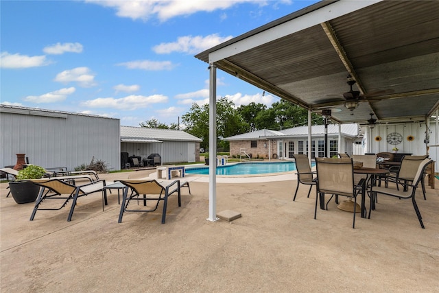 outdoor pool with a ceiling fan, outdoor dining space, and a patio area