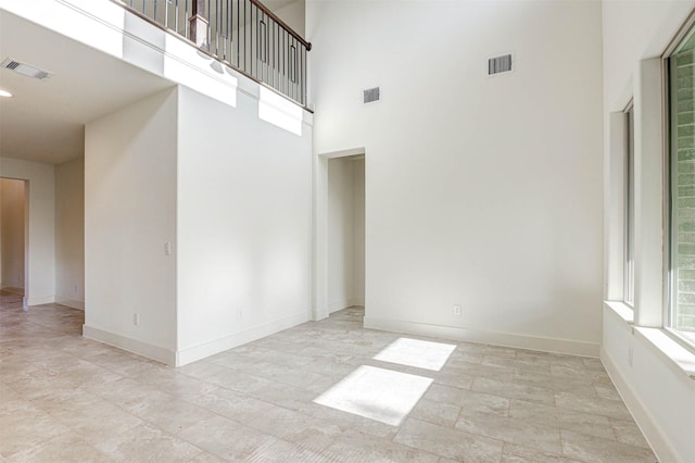 929 Ryed Ln, Fort Worth, TX 76120 - empty room featuring baseboards, a high ceiling, and visible vents