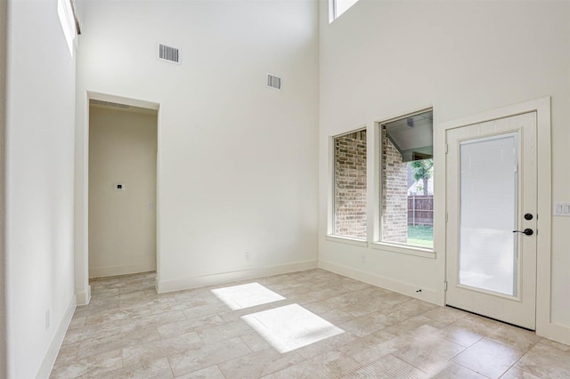 929 Ryed Ln, Fort Worth, TX 76120 - interior space featuring baseboards, visible vents, and a towering ceiling