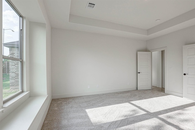 929 Ryed Ln, Fort Worth, TX 76120 - unfurnished bedroom with light colored carpet, a tray ceiling, visible vents, and baseboards