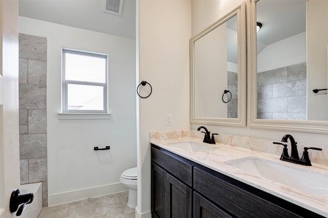 929 Ryed Ln, Fort Worth, TX 76120 - bathroom with toilet, baseboards, visible vents, and a sink