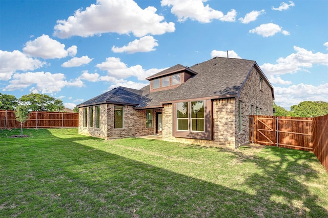 929 Ryed Ln, Fort Worth, TX 76120 - rear view of house with brick siding, a fenced backyard, roof with shingles, and a yard