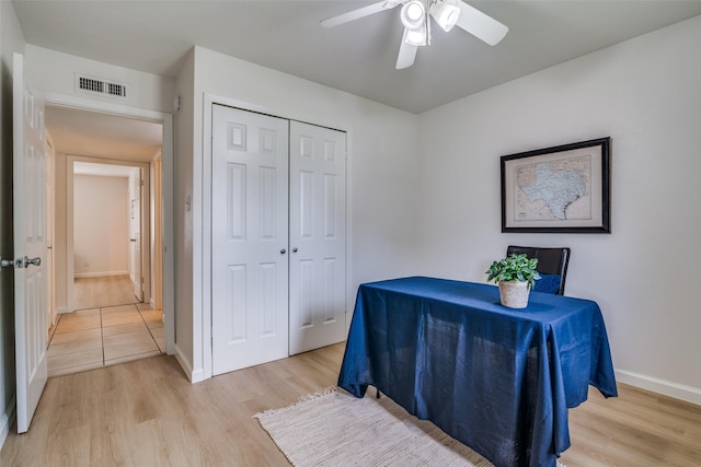 bedroom featuring baseboards, a closet, light wood finished floors, and visible vents