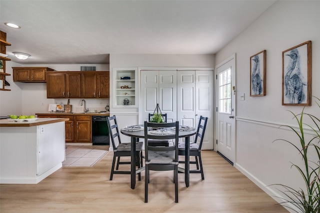 dining room with baseboards, light wood finished floors, and visible vents