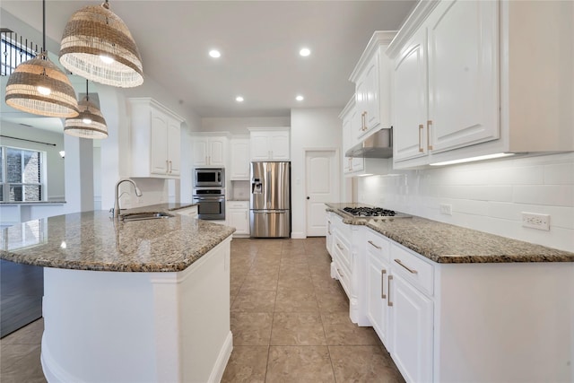 6917 Moody Ave, Frisco, TX 75035 - kitchen featuring stainless steel appliances, under cabinet range hood, a peninsula, tasteful backsplash, and dark stone countertops