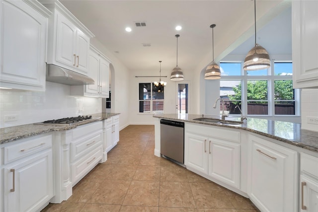 6917 Moody Ave, Frisco, TX 75035 - kitchen with stainless steel appliances, backsplash, under cabinet range hood, white cabinetry, and recessed lighting