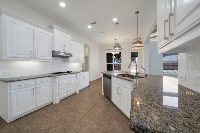 6917 Moody Ave, Frisco, TX 75035 - kitchen featuring stainless steel appliances, under cabinet range hood, backsplash, dark stone counters, and white cabinetry