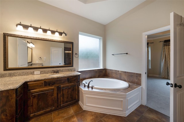 bathroom featuring vanity, a garden tub, and tile patterned floors