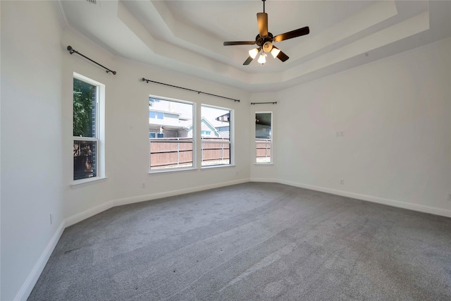 6917 Moody Ave, Frisco, TX 75035 - empty room featuring dark colored carpet, a tray ceiling, and ceiling fan