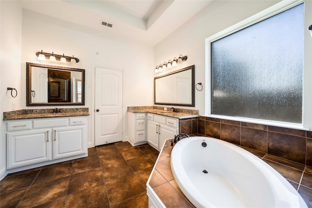 6917 Moody Ave, Frisco, TX 75035 - bathroom with a bath and two vanities