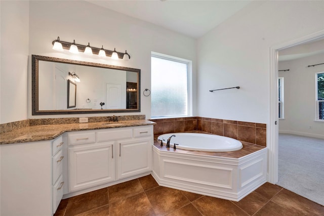 6917 Moody Ave, Frisco, TX 75035 - bathroom featuring vanity, a garden tub, and tile patterned flooring