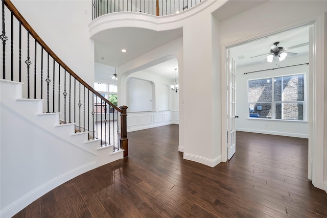 6917 Moody Ave, Frisco, TX 75035 - entrance foyer featuring a ceiling fan, arched walkways, wood-type flooring, stairway, and a high ceiling