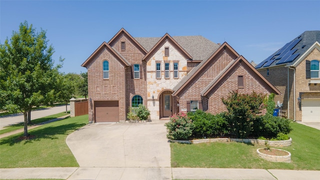 6917 Moody Ave, Frisco, TX 75035 - french country inspired facade with an attached garage, concrete driveway, brick siding, and a front yard