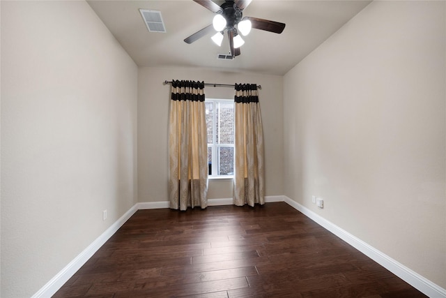 spare room featuring a ceiling fan, dark wood-type flooring, baseboards, and visible vents