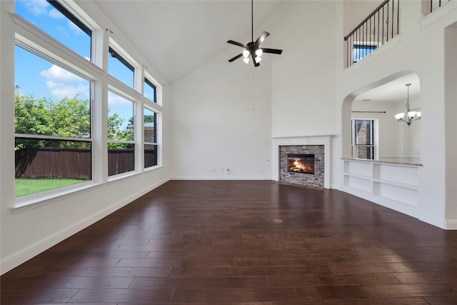 6917 Moody Ave, Frisco, TX 75035 - unfurnished living room featuring a fireplace, a ceiling fan, a chandelier, high vaulted ceiling, and dark wood finished floors