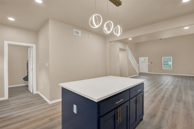 703 S Montgomery St, Sherman, TX 75090 - kitchen featuring light wood-type flooring, baseboards, recessed lighting, light countertops, and a kitchen island