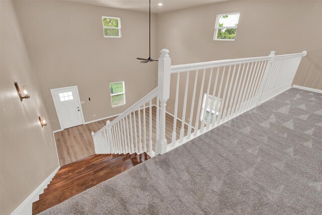703 S Montgomery St, Sherman, TX 75090 - stairway with healthy amount of natural light, wood finished floors, a high ceiling, and baseboards