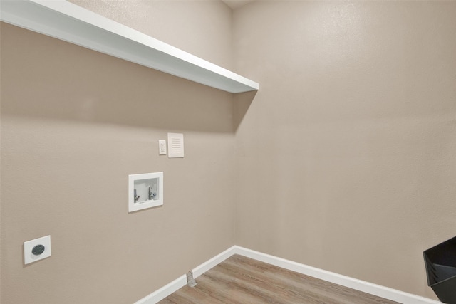 703 S Montgomery St, Sherman, TX 75090 - washroom featuring hookup for a washing machine, light wood-style flooring, baseboards, and electric dryer hookup