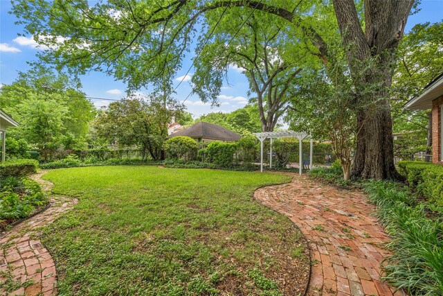 view of yard featuring a pergola and a fenced backyard