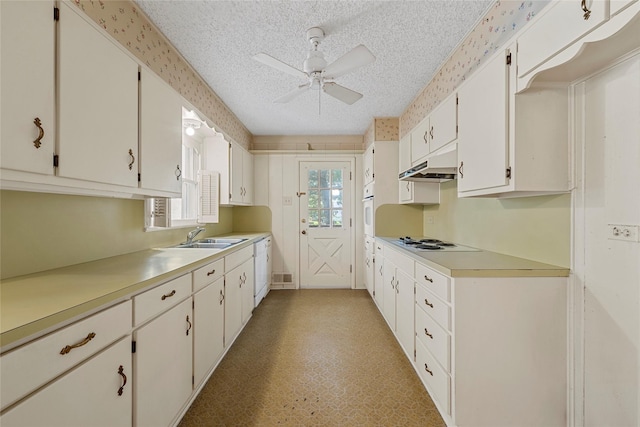 kitchen with ceiling fan, white appliances, light countertops, a textured ceiling, and under cabinet range hood