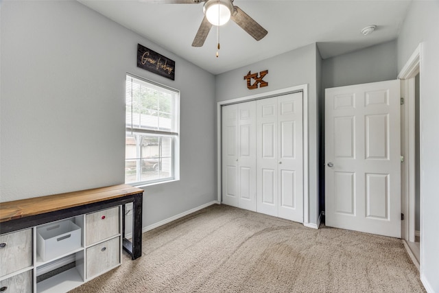unfurnished bedroom with a ceiling fan, baseboards, carpet, and a closet